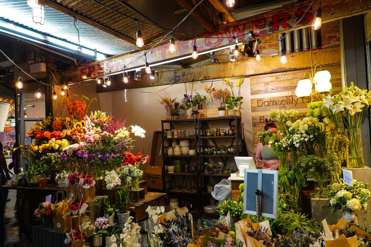 A neighborhood flower shop in the evening