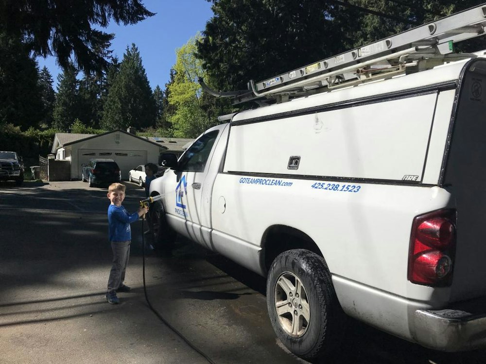 A white service truck parked on a residential street